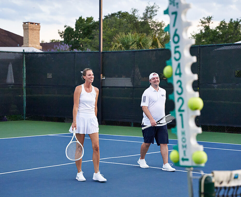 man and woman on tennis court